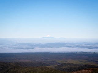 Solitary Snow Capped Volcano Mountain Poking Through Clouds Mt Taranki, New Zealand