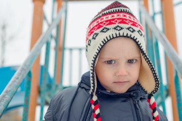 the boy poses with a winter cap