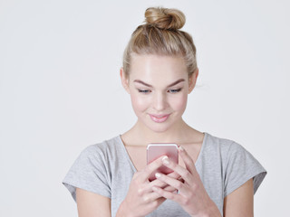 Attractive young woman holds mobile phone