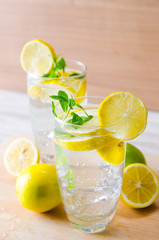 Glasss of mojito with lemon and drinking straw