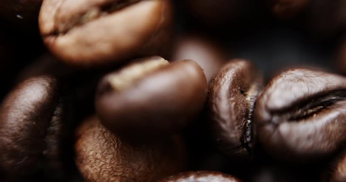 Closeup slow motion shot of roasted coffee beans