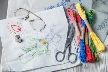 Embroidered napkins made of colored threads on white table