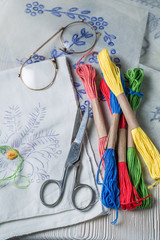 Closeup of colored threads and embroidered napkins