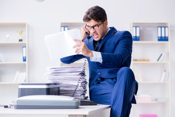 Businessman making copies in copying machine