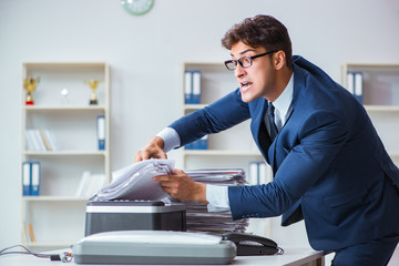 Businessman making copies in copying machine