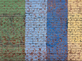 Green, blue and yellow painted brick wall background