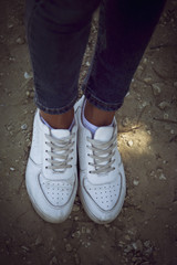 Summer trips. Young woman standing on a  mountain road  and is ready for summer vacation and travel adventure.
