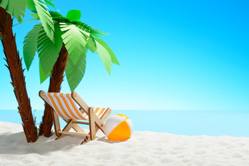 Sun lounger and beach ball under a palm tree on the sandy coast. Sky with copy space