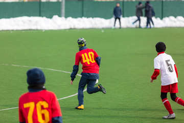 Obraz premium young boys play football, show dribbling, make passes to win on the winter field