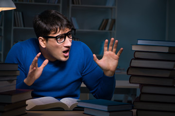 Student preparing for exams late at night in library