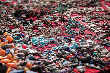 Colorful necklaces for sale at the flea market, consumption background