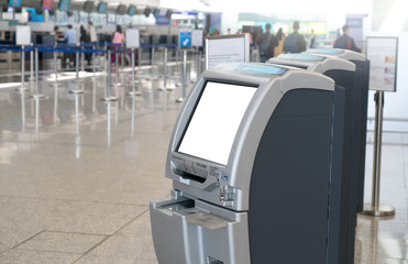 Self service check-in kiosks at International Airport for passenger. Close up of blank screen electronic self check-in kiosk in main terminal.