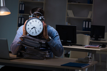 Young employee working overtime to meet deadline