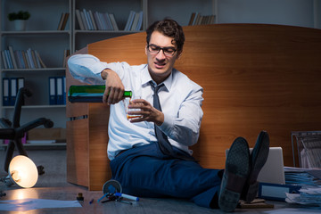 Stressed businessman working overtime in depression
