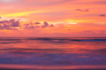 Naklejka na ściany i meble Dramatic clouds and sunset sky reflection on the sea.