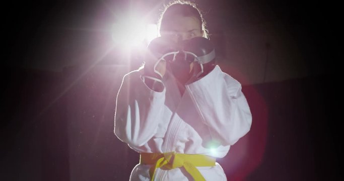 Young female martial artist shadow practicing in slow motion.