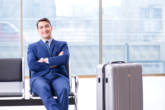 Businessman waiting at the airport for his plane in business cla