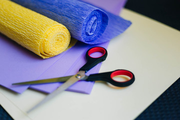 tools for handmade. Rolls of corrugated paper, glue gun and scissors. Counterfeits from colored...