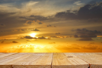 Fototapeta na wymiar wood board table in front of golden sunset. product display background.