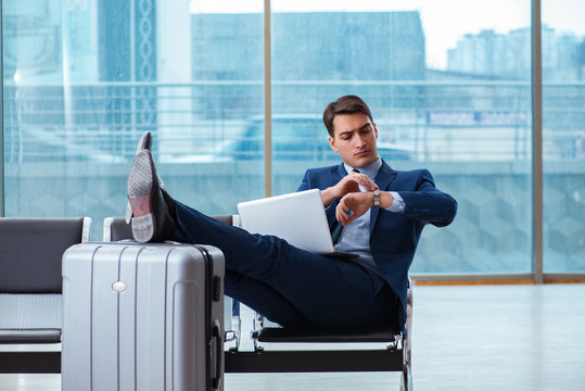 Businessman waiting at the airport for his plane in business cla