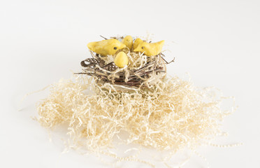 birds of wax in a nest of branches with straw