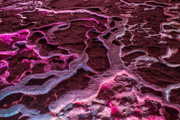 Violet ice cave covered with snow and flooded  