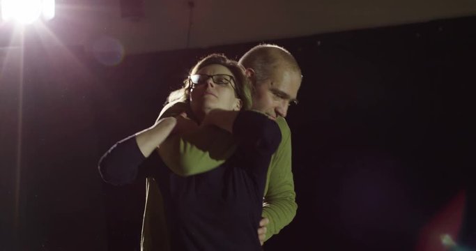Martial arts athletes showcase self defense techniques in slow motion.