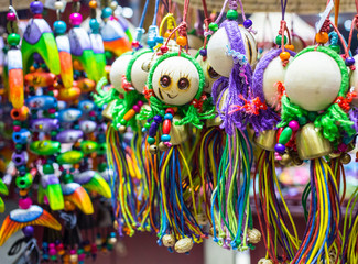 Unidentified chinese street market visitor buy funny soft toy, give money to seller women.