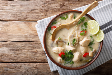 Thai chicken soup tom kha gai close-up in a bowl. horizontal top view from above