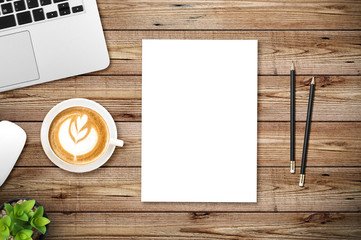 Top view of blank paper page on wood background office desk and different objects. Minimal flat lay style