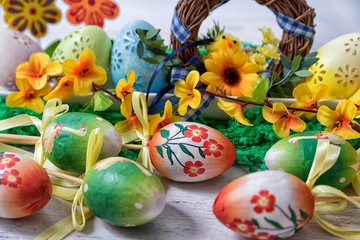 Easter, painted Easter eggs set in a bowl Easter decoration behind a white background