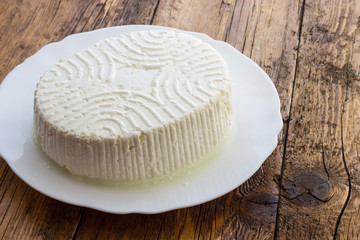Fototapeta na wymiar Tasty fresh cow Ricotta cheese