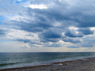 Stormy clouds at Black sea beach. On the sandy beach before a powerful storm