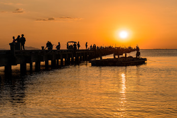 fisher man boat silhouette on the sea with sunset sky