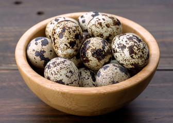 raw quail eggs on wood