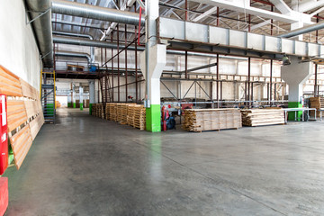 Fototapeta na wymiar Warehouse of lumber at the woodworking plant. Shop woodworking plant