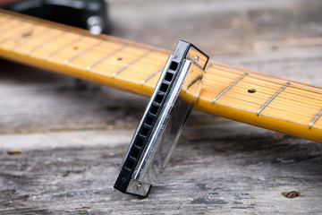 guitar with blues harmonica on wooden ground - obrazy, fototapety, plakaty