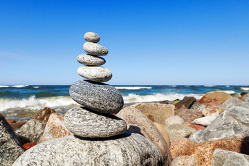 Gray zen stones on the background of the sea. Concept of harmony, balance and meditation.