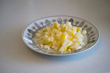 Cottage cheese with pear on the plate. Fresh curd, sour cream and pear for healthy eating.