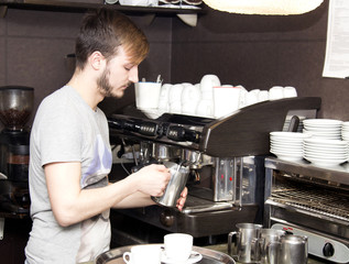 waiter preparing a coffee at the bar