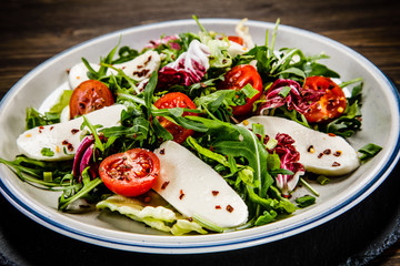 Greek salad on wooden background