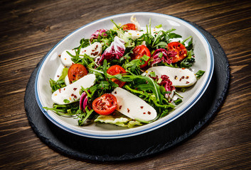 Greek salad on wooden background
