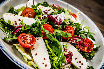 Greek salad on wooden background