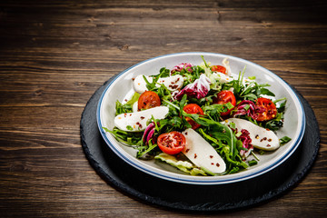 Greek salad on wooden background
