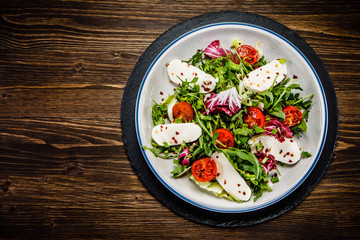 Greek salad on wooden background