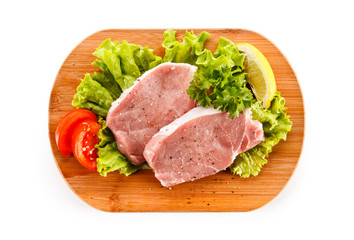 Fresh raw pork on cutting board on white background