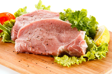 Fresh raw pork on cutting board on white background