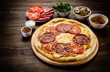Pizza with salami, mushrooms and vegetables