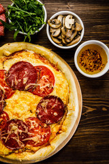 Pizza with salami, mushrooms and vegetables