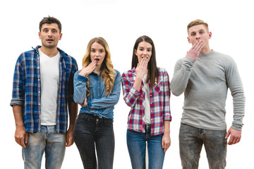 The four surprised people stand on the white background